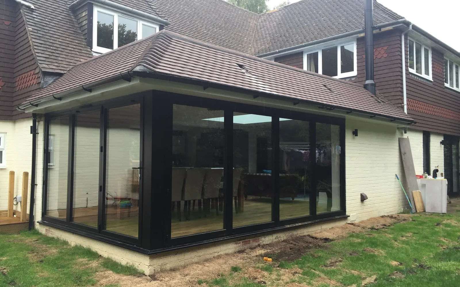 New glazed rear extension with dark frames on a family home